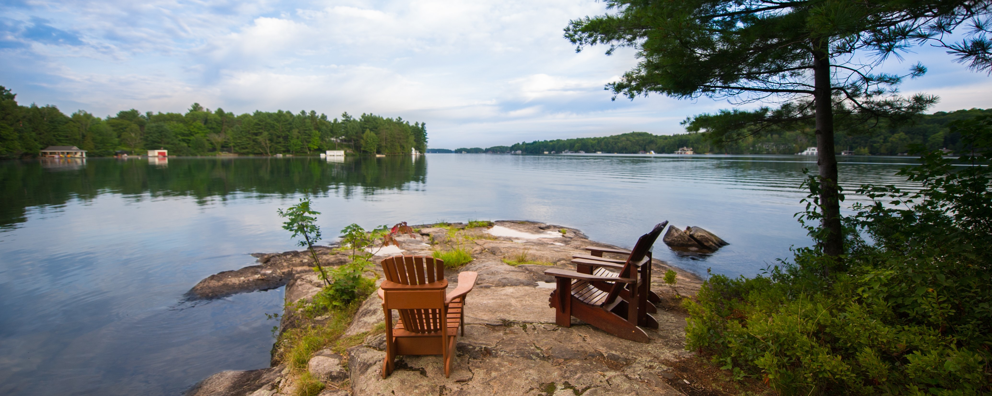 Two empty chairs in front of Lake Joseph, Ontario. 
